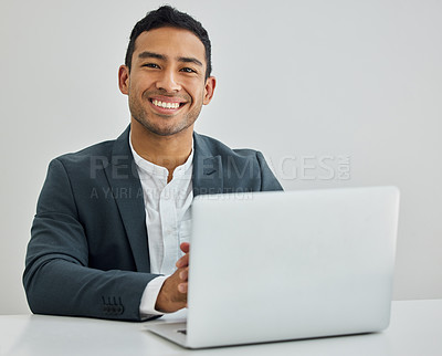 Buy stock photo Portrait of a businessman using a laptop at his desk in a modern office