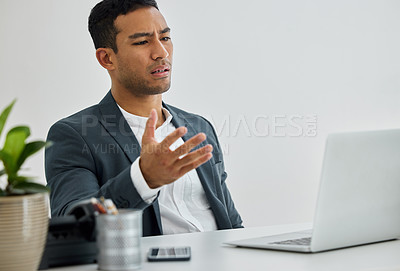 Buy stock photo Shot of a businessman being frustrated while using his laptop at his desk in a modern office