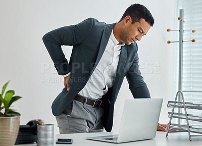 Buy stock photo .shot of a businessman suffering backache in a modern office