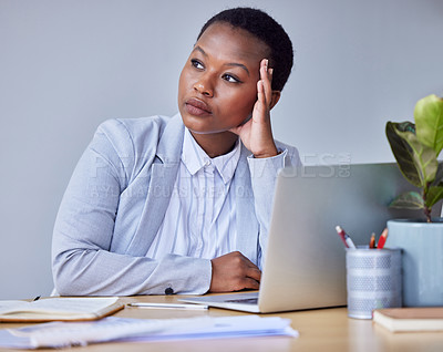 Buy stock photo Shot of a young businesswoman looking bored at work