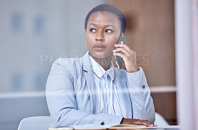 Buy stock photo Shot of a young businesswoman using her smartphone to make a phone call