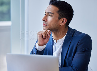 Buy stock photo Shot of a young man taking a break to day dream at work