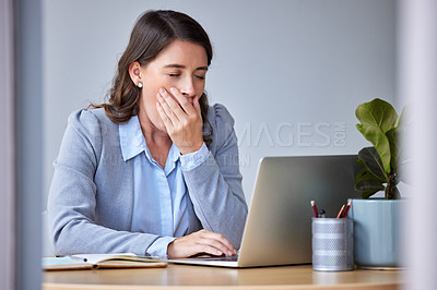 Buy stock photo Shot of a young businesswoman yawning in exhaustion