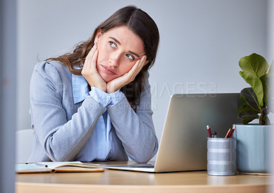 Buy stock photo Shot of a young businesswoman feeling bored at work