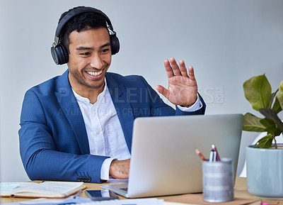 Buy stock photo Shot of a young businessman using his laptop to do a video call