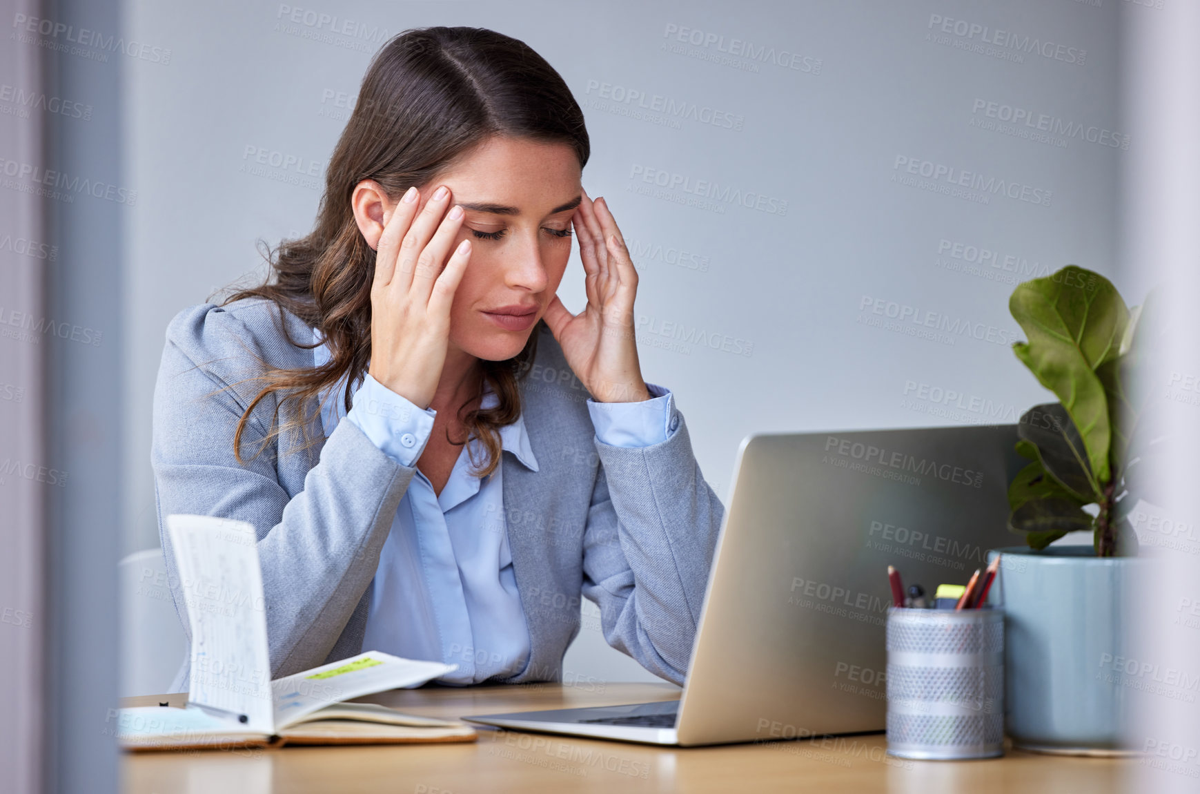 Buy stock photo Shot of a businesswoman experiencing a headache at work