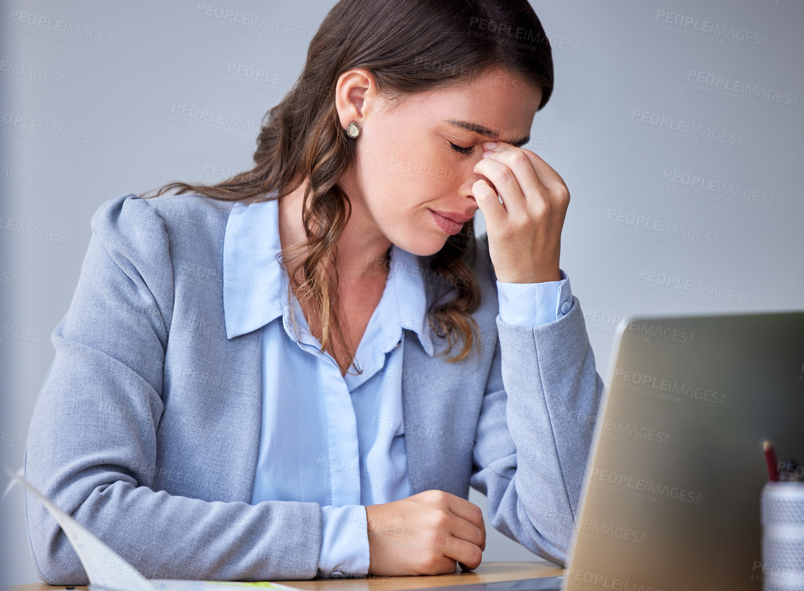 Buy stock photo Shot of a businesswoman experiencing a headache at work