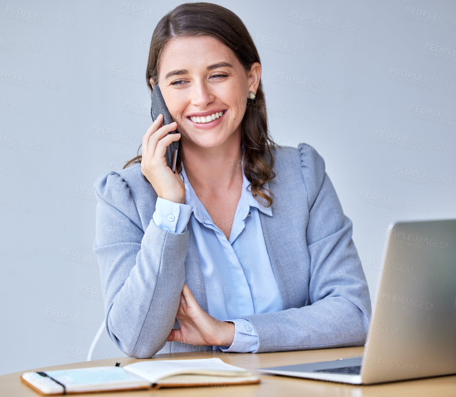 Buy stock photo Shot of a young businesswoman using her smartphone to make a phone call