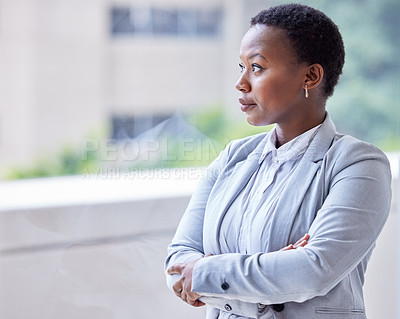 Buy stock photo Shot of a young businesswoman looking out of the window
