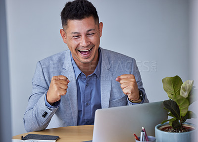 Buy stock photo Shot of a young businessman cheering after being lucky in trading