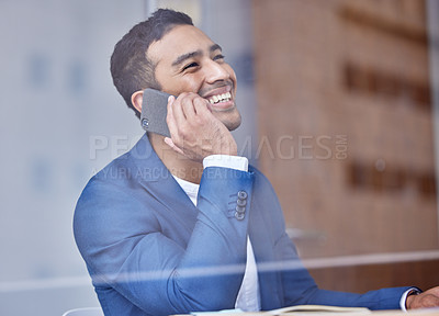 Buy stock photo Shot of a young businessman using his smartphone to make a phone call