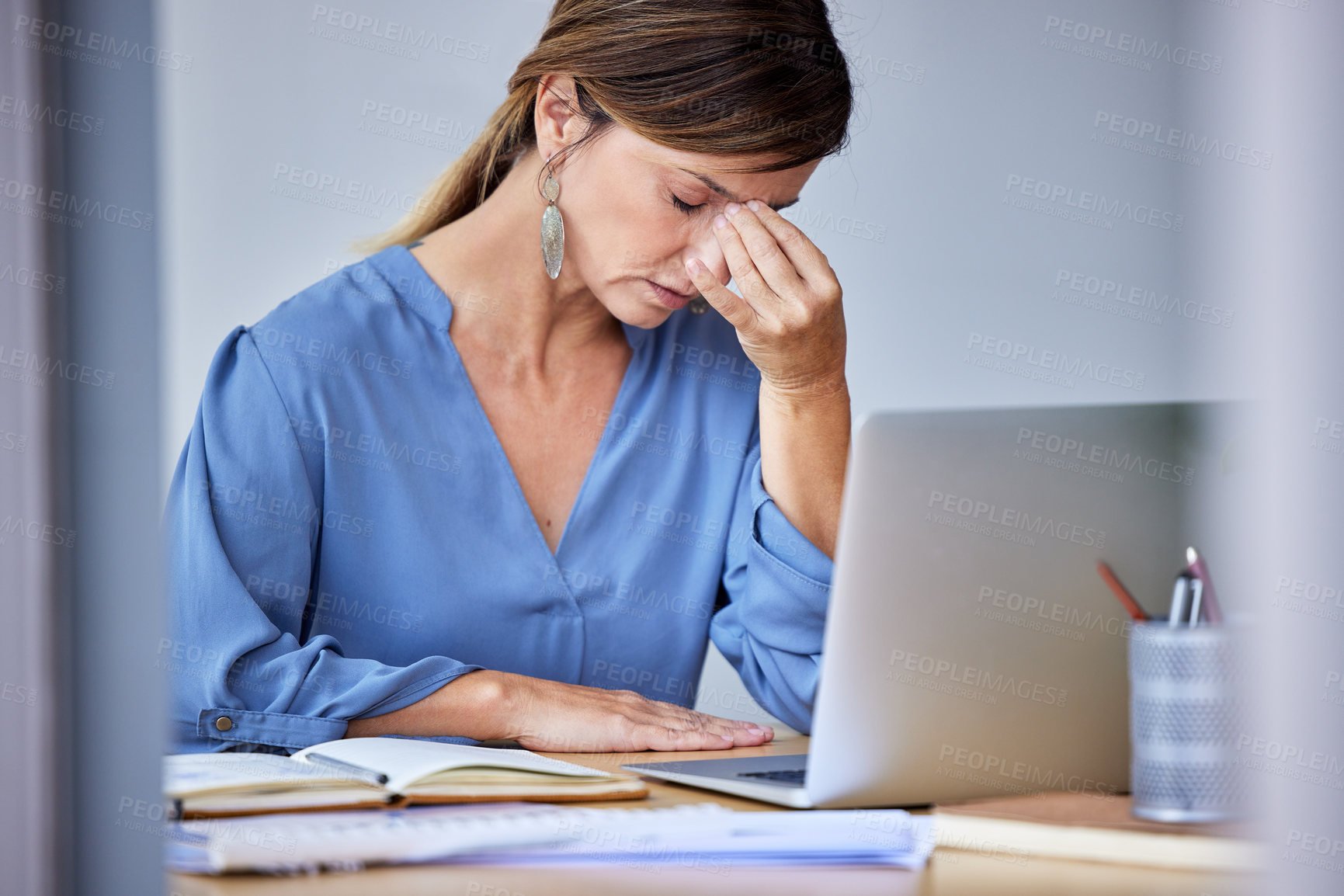 Buy stock photo Shot of a businesswoman experiencing a headache at work