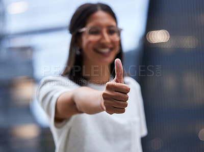 Buy stock photo Shot of a young businesswoman Showing thumbs up while standing outside the office