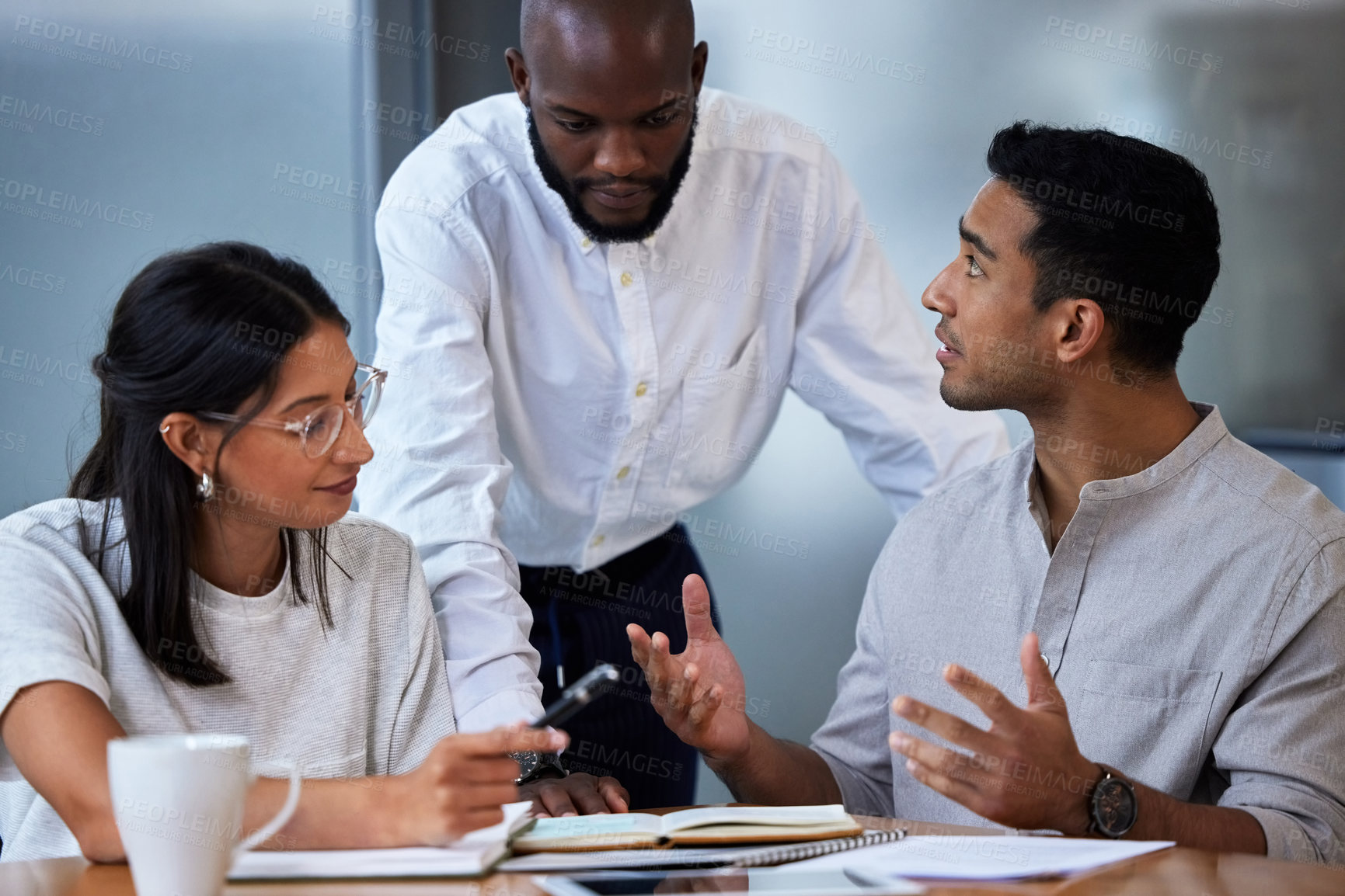 Buy stock photo Shot of diverse group of businesspeople having a quick meeting in an office