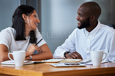 Buy stock photo Shot of two businesspeople sitting at a desk in a modern office