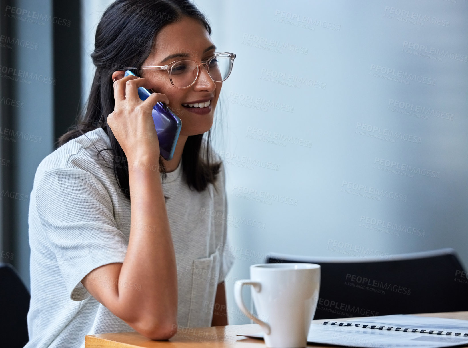 Buy stock photo Shot of a young woman having coffee and working in a modern office