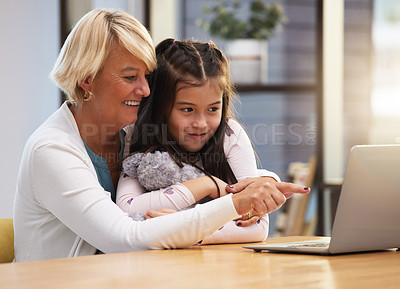 Buy stock photo Girl, grandma and online in house with laptop for e learning, home schooling and reading e books for growth and development. Child, grandmother and technology, typing and education with internet.