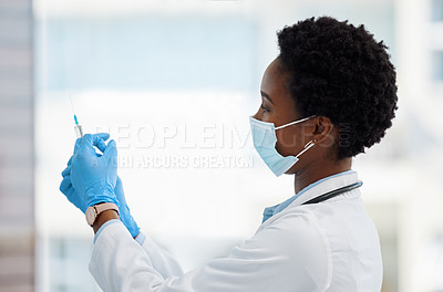 Buy stock photo Shot of a doctor preparing a needle for injection