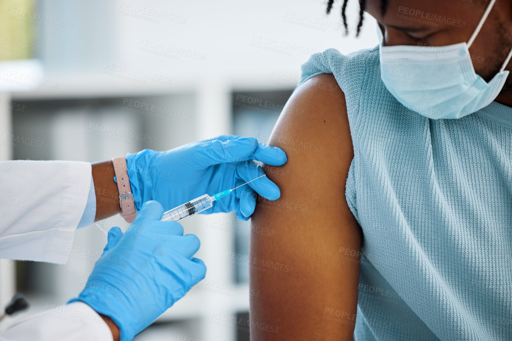 Buy stock photo Shot of a doctor giving her patient an injection