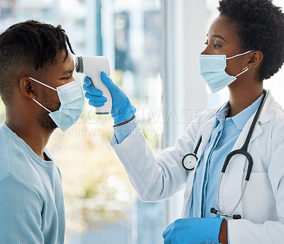 Buy stock photo Shot of a female doctor taking the temperature of her patient