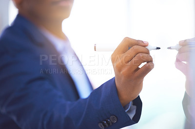 Buy stock photo Shot of an unrecognizable businessman making notes on a glass screen against a bright background