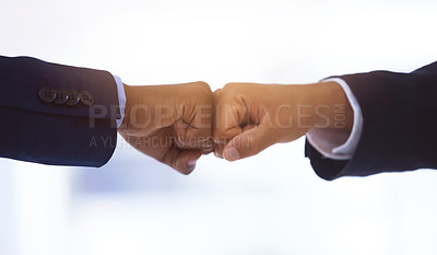 Buy stock photo Shot of two unrecognizable businessmen bumping fists against a white background
