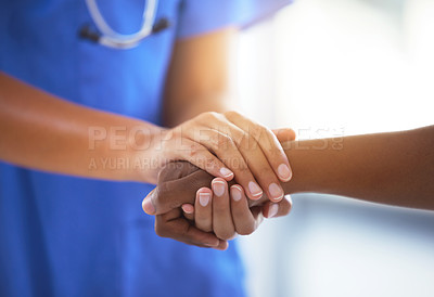 Buy stock photo Shot of an unrecognizable doctor holding hands with her patient during a consultation