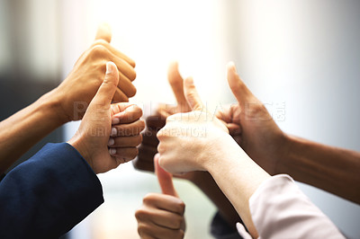 Buy stock photo Shot of a group of unrecognizable businesspeople showing thumbs up in an office