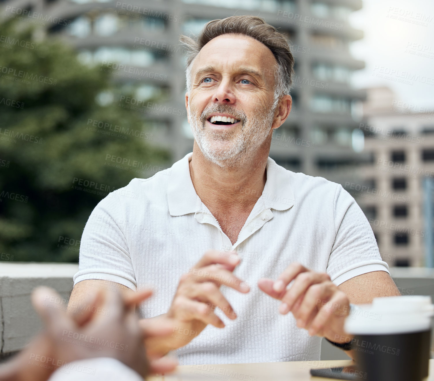 Buy stock photo Shot of a mature businessman having a break with his colleagues outside an office