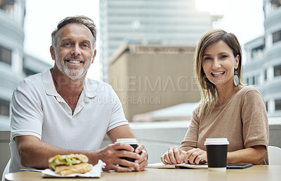 Buy stock photo Portrait of two businesspeople having lunch together outside an office