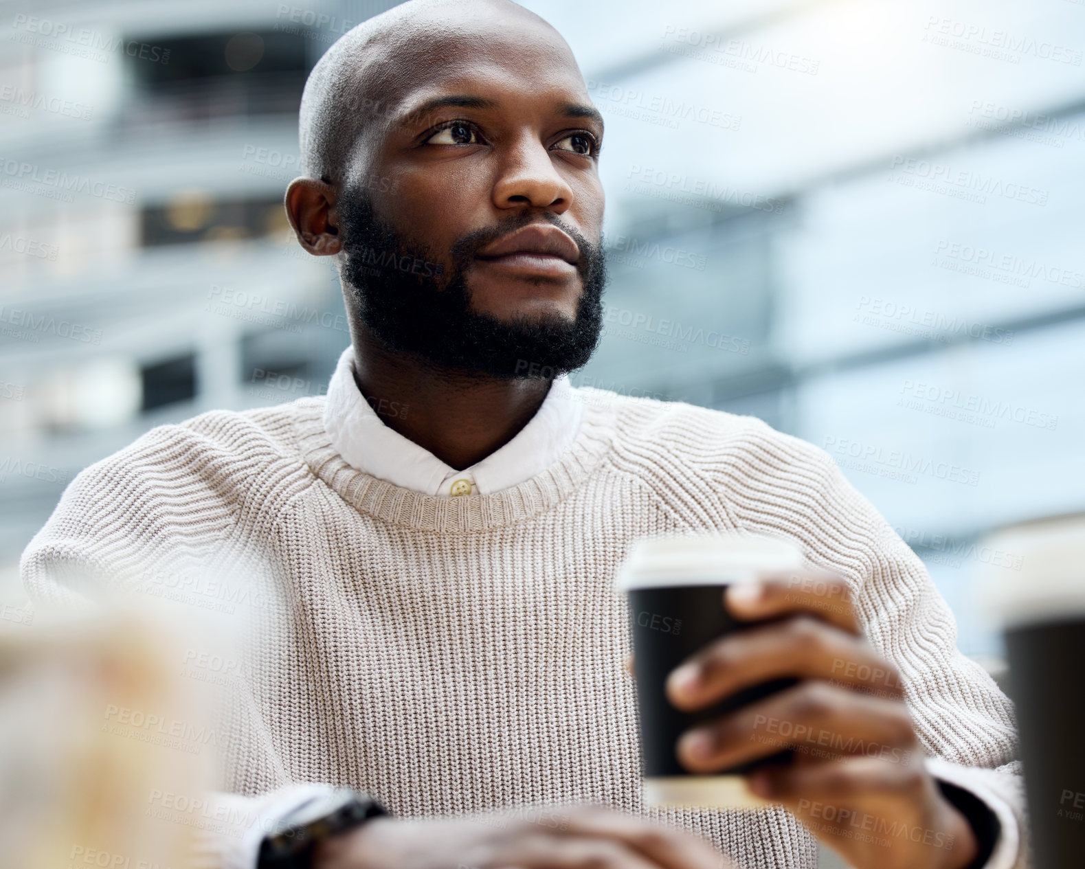 Buy stock photo Shot of a young businessman looking thoughtful while drinking coffee outside an office