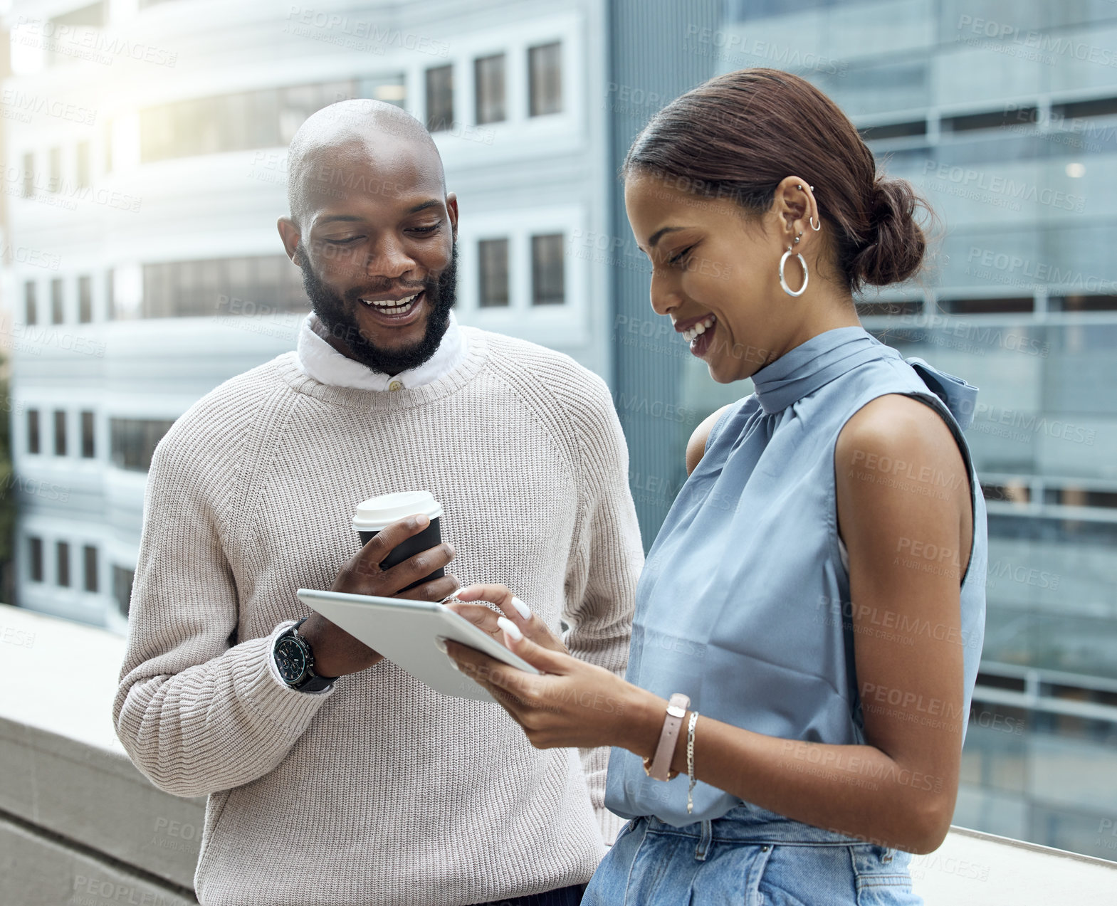 Buy stock photo Shot of two businesspeople using a digital tablet together outside an office