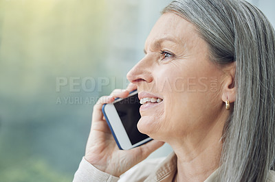Buy stock photo Cropped shot of an attractive mature businesswoman making a phonecall while standing on the balcony of her office