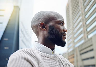 Buy stock photo Low angle shot of a handsome young businessman looking thoughtful while standing on the balcony of his office