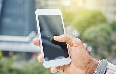 Buy stock photo High angle shot of an unrecognizable businessman sending a text message while standing on the balcony of his office