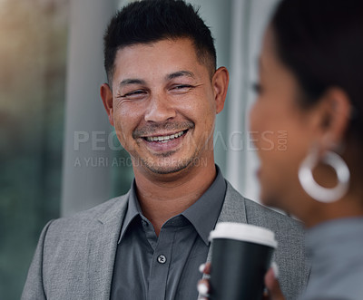 Buy stock photo Shot of a handsome young businessman standing and having a discussion with a coworker in the office during a late shift