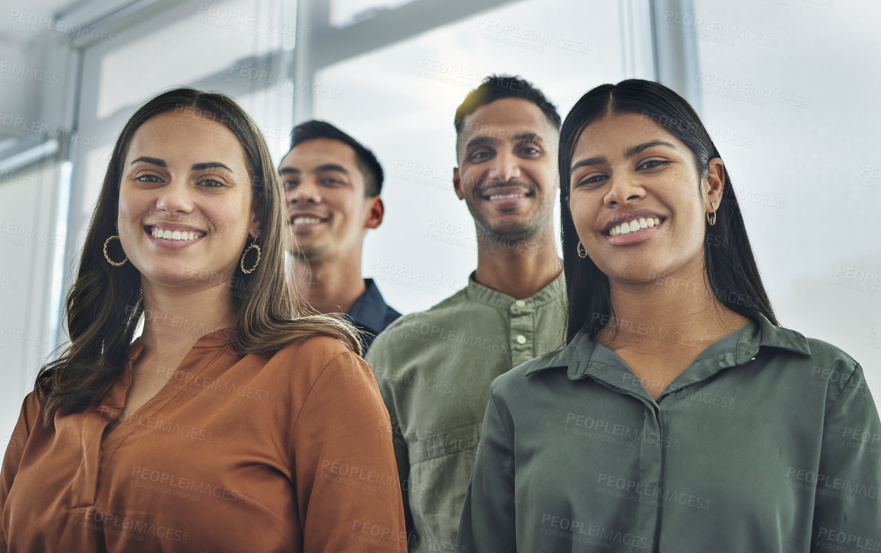Buy stock photo Cropped portrait of a young group of businesspeople standing together in their office