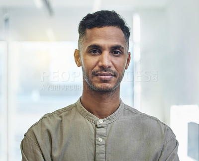 Buy stock photo Cropped portrait of a handsome young businessman standing in his office