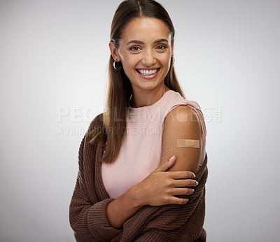 Buy stock photo Shot of a young woman standing alone in the studio after getting vaccinated