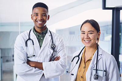 Buy stock photo Cropped portrait of two young doctors standing next to each other in the hospital