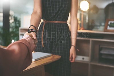 Buy stock photo Cropped shot of two unrecognizable businesspeople shaking hands during a meeting in the office