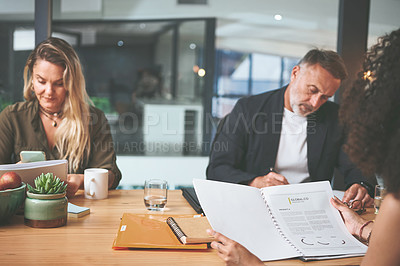 Buy stock photo Shot of a diverse group of businesspeople sitting together in the office and planning during a meeting