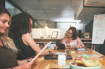 Buy stock photo Shot of a diverse group of businesspeople sitting together in the office and planning during a meeting