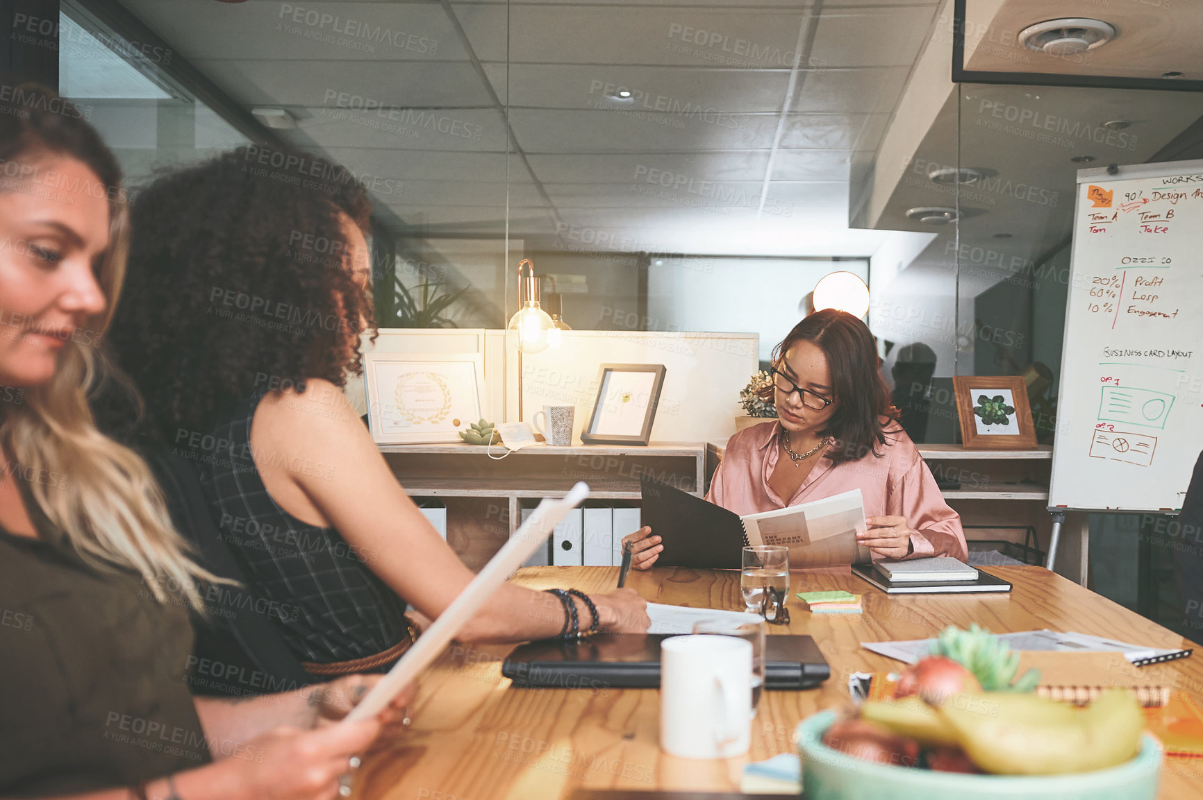 Buy stock photo Shot of a diverse group of businesspeople sitting together in the office and planning during a meeting