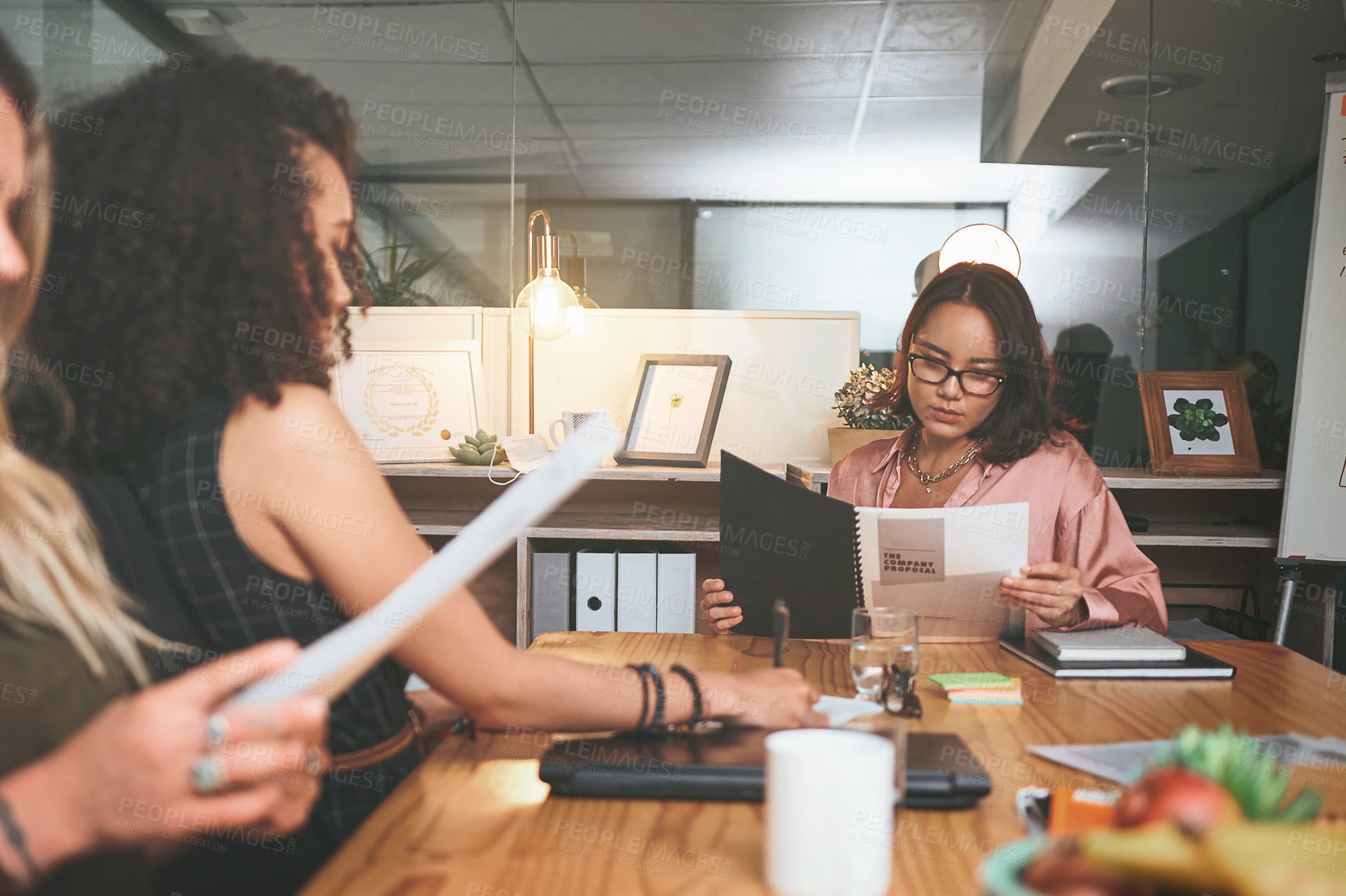 Buy stock photo Shot of a diverse group of businesspeople sitting together in the office and planning during a meeting