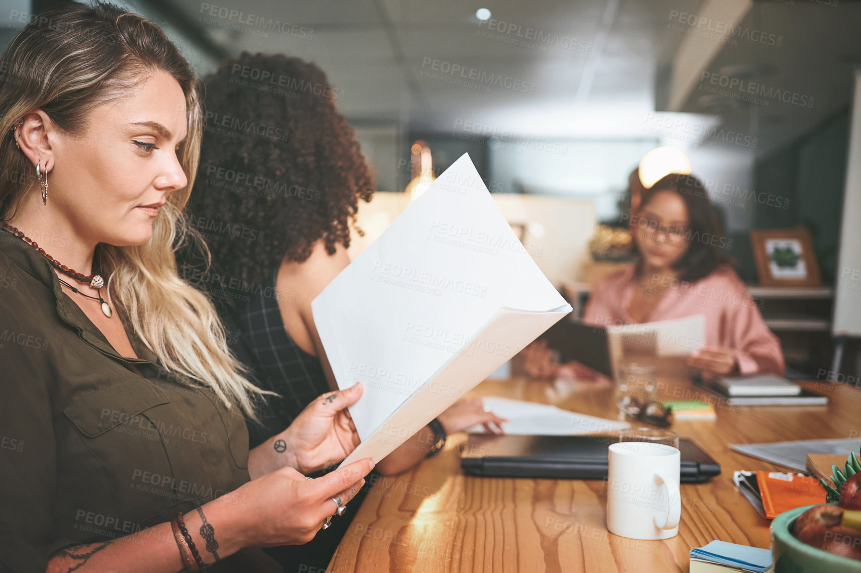 Buy stock photo Shot of a diverse group of businesspeople sitting together in the office and planning during a meeting