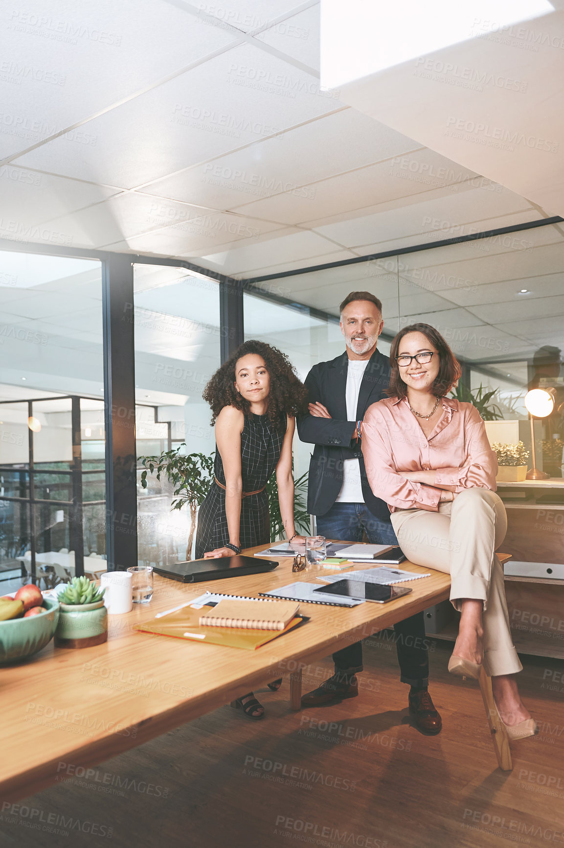 Buy stock photo Shot of a diverse group of businesspeople standing together in the office during a meeting