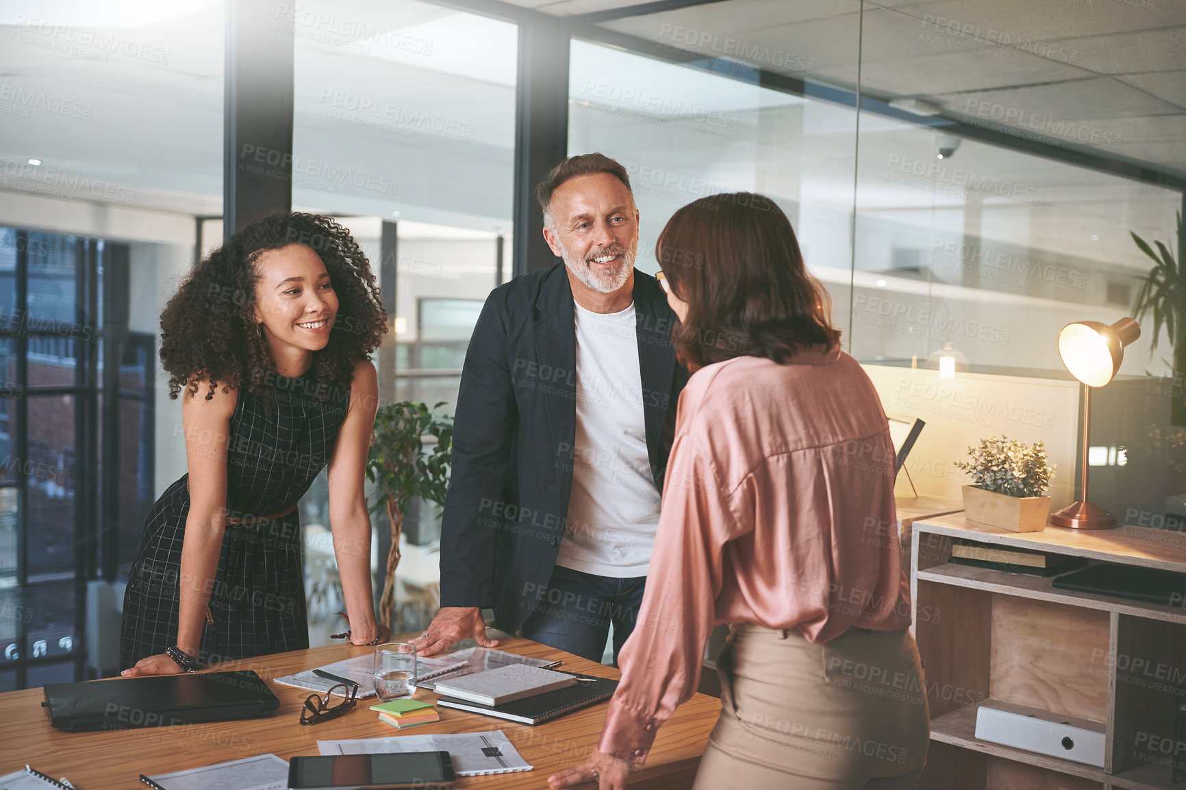 Buy stock photo Shot of a diverse group of businesspeople standing together in the office during a meeting