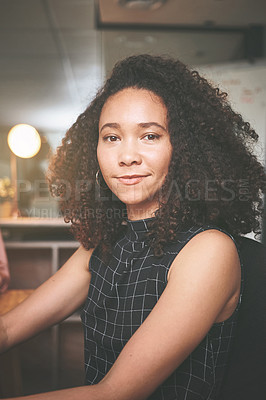 Buy stock photo Shot of an attractive young businesswoman sitting alone in the office at night