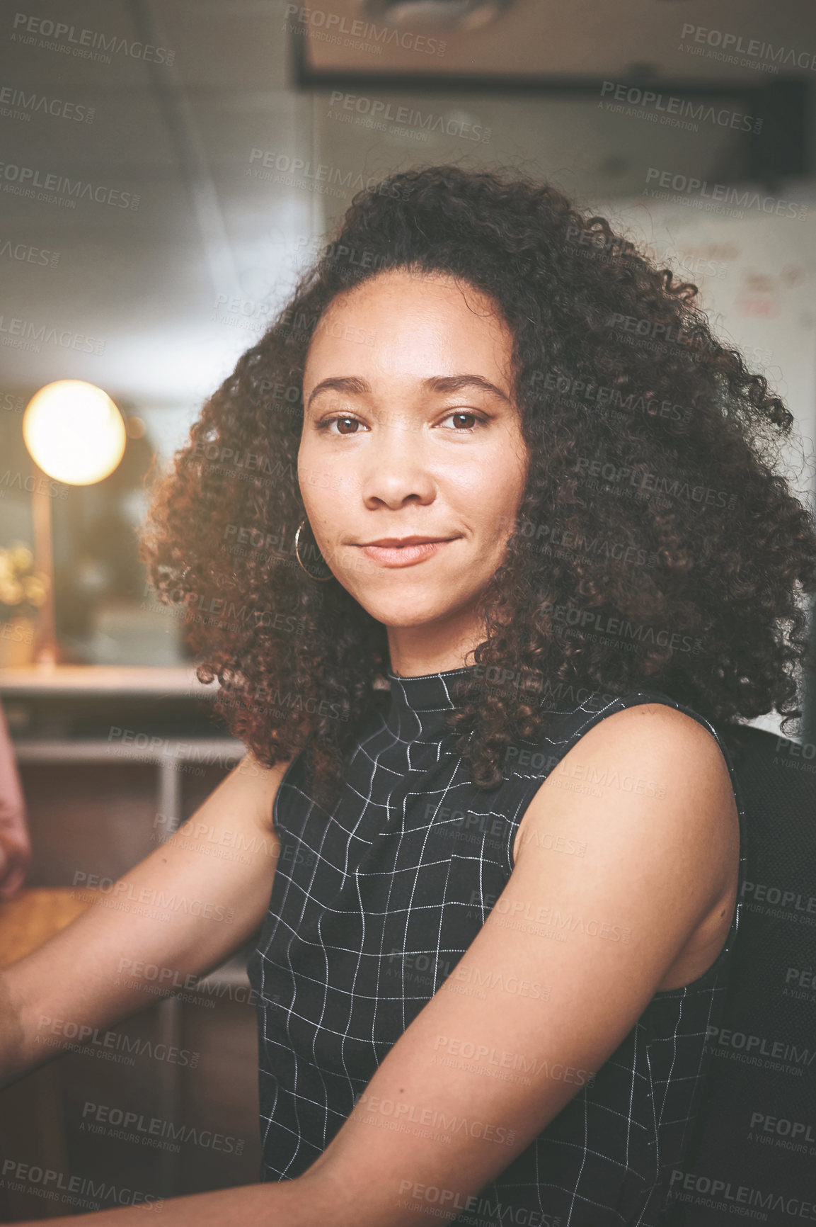 Buy stock photo Shot of an attractive young businesswoman sitting alone in the office at night